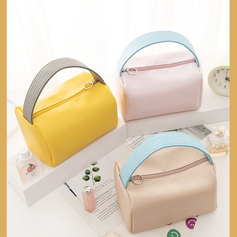Cross-border PU solid color cosmetic bag, large-capacity waterproof toiletry bag, high-value travel outlet, hand-to-hand storage bag