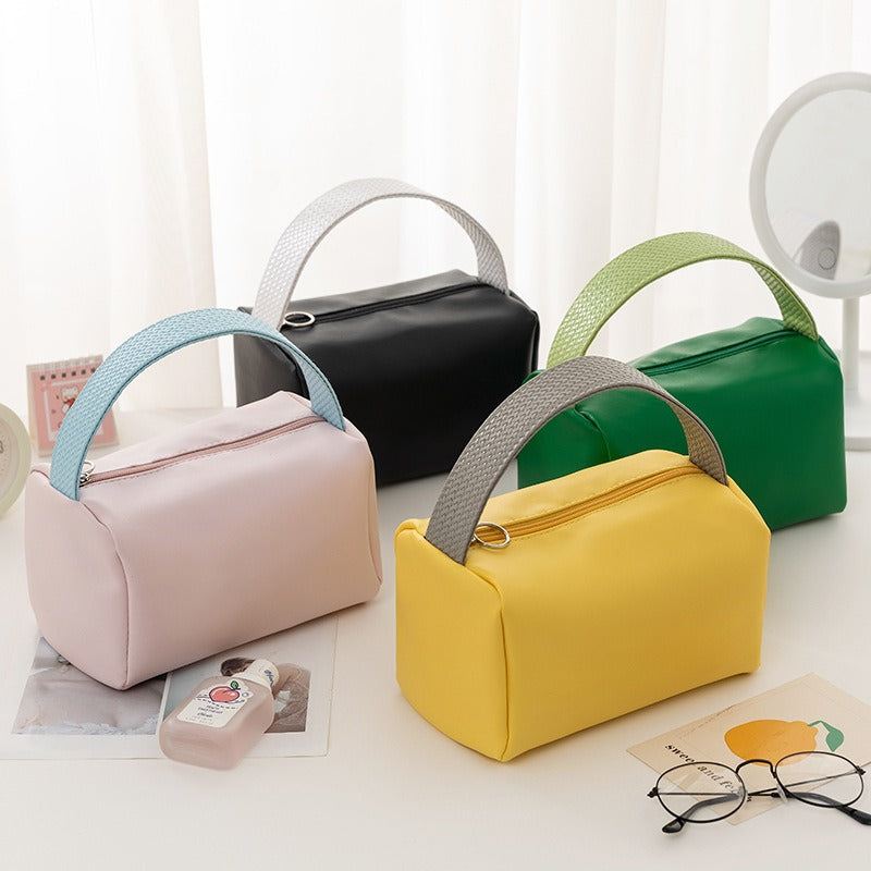Cross-border PU solid color cosmetic bag, large-capacity waterproof toiletry bag, high-value travel outlet, hand-to-hand storage bag