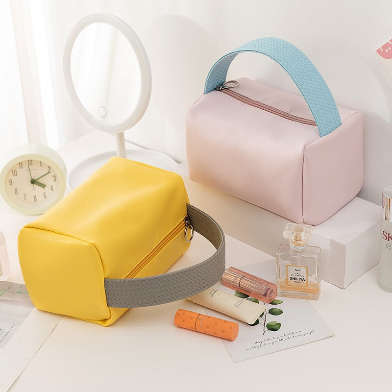 Cross-border PU solid color cosmetic bag, large-capacity waterproof toiletry bag, high-value travel outlet, hand-to-hand storage bag