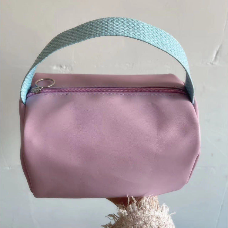 Cross-border PU solid color cosmetic bag, large-capacity waterproof toiletry bag, high-value travel outlet, hand-to-hand storage bag
